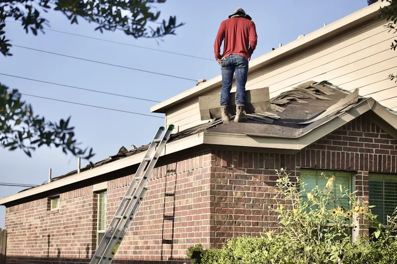 Professional roofer working on a residential roof in London Terrace